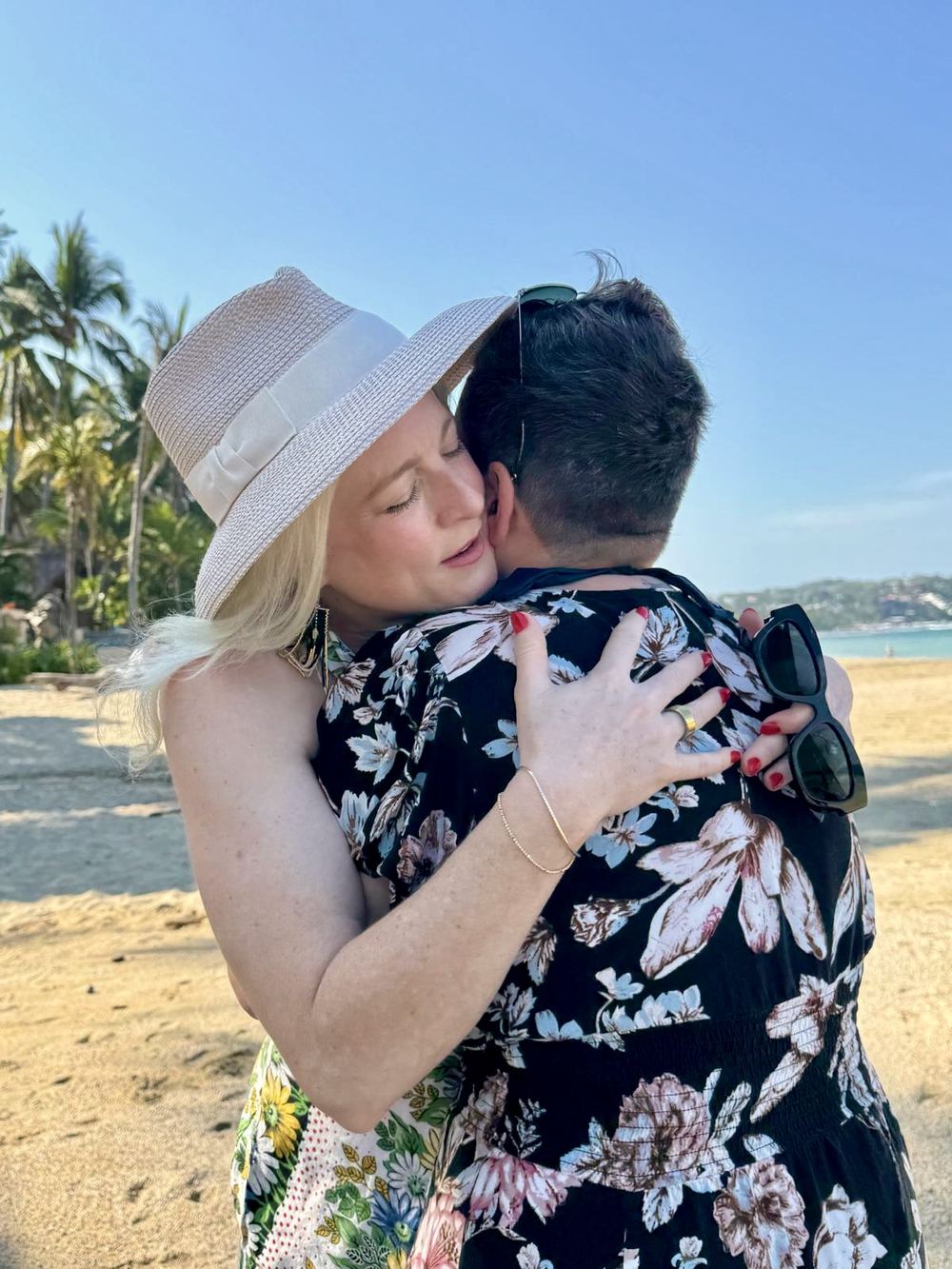 Two women embracing on the beach